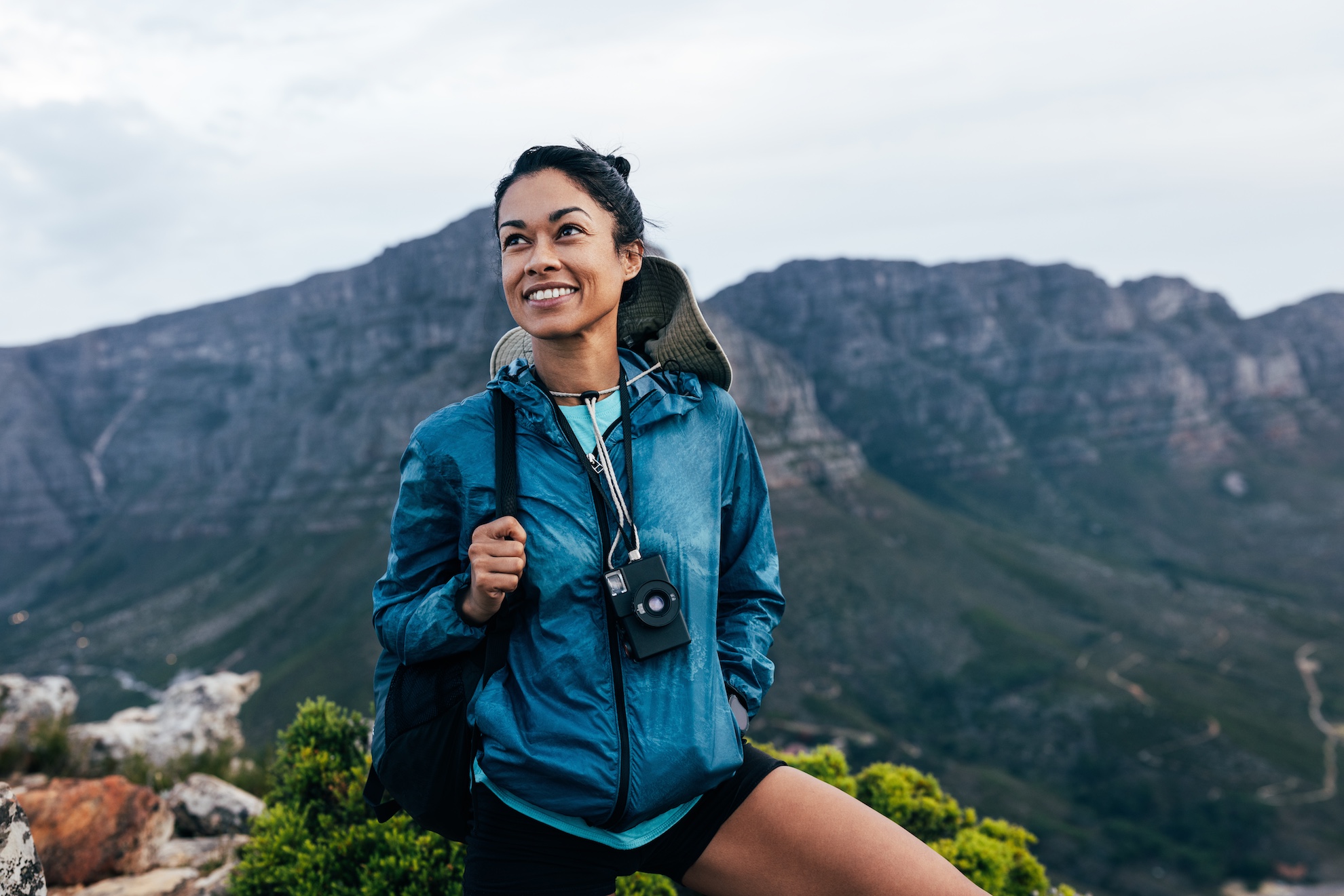 Woman hiking with backpack in mountains